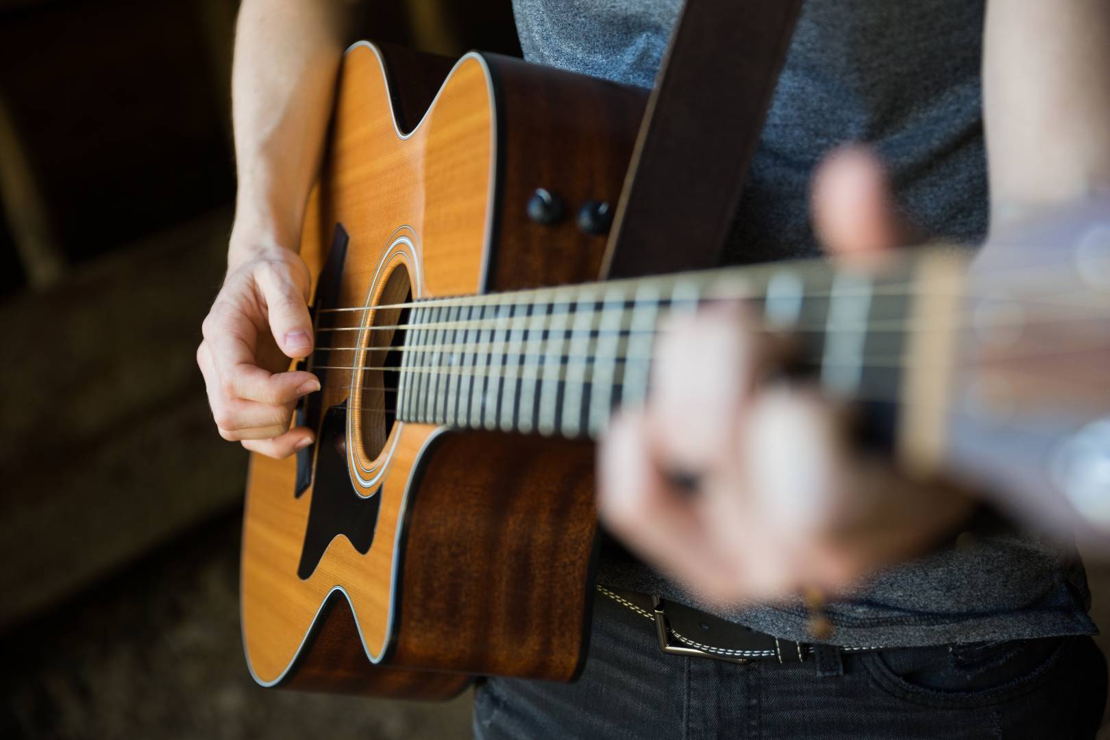 A photo of someone playing an acoustic guitar.