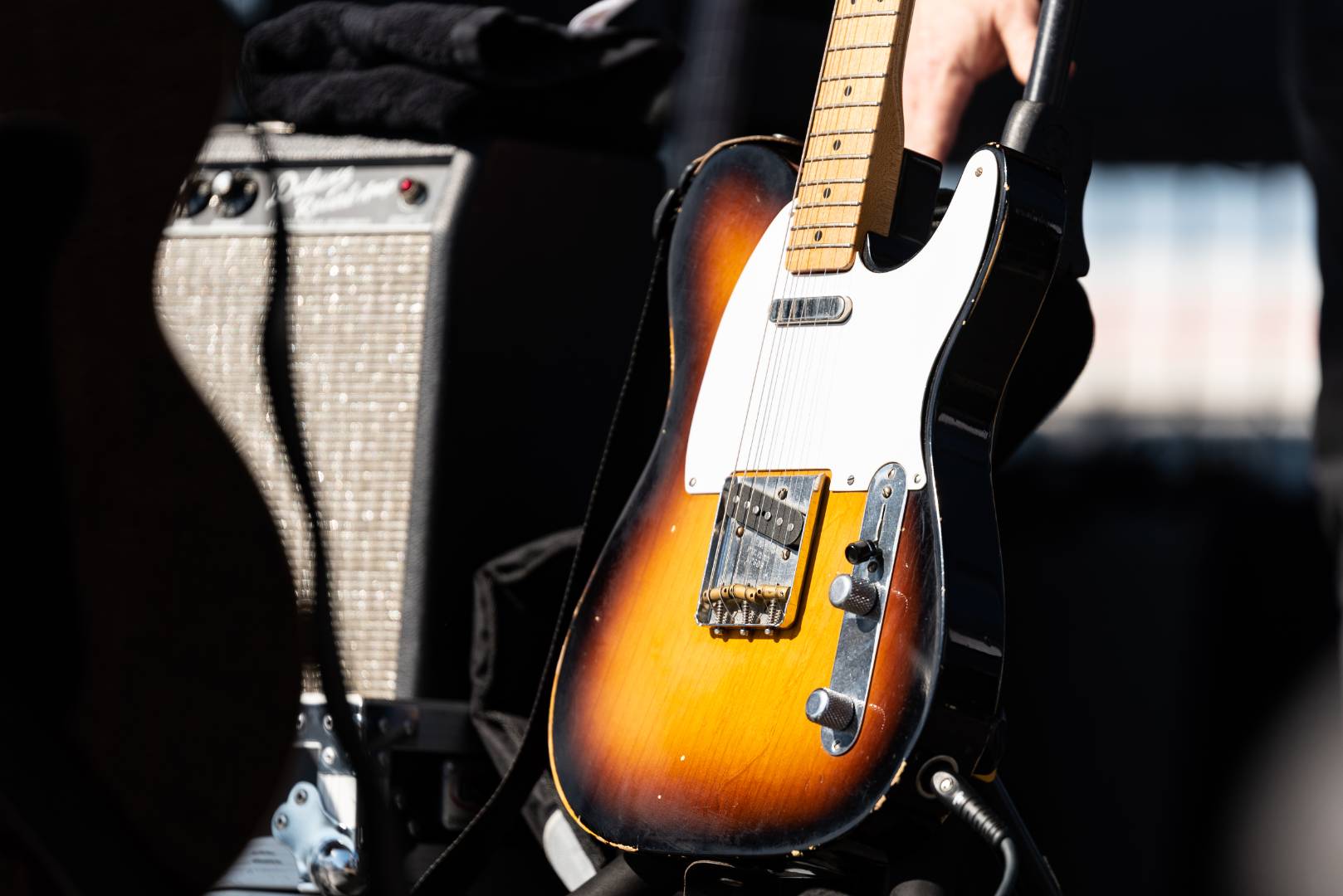 A low-angle photo of a brown electric guitar.