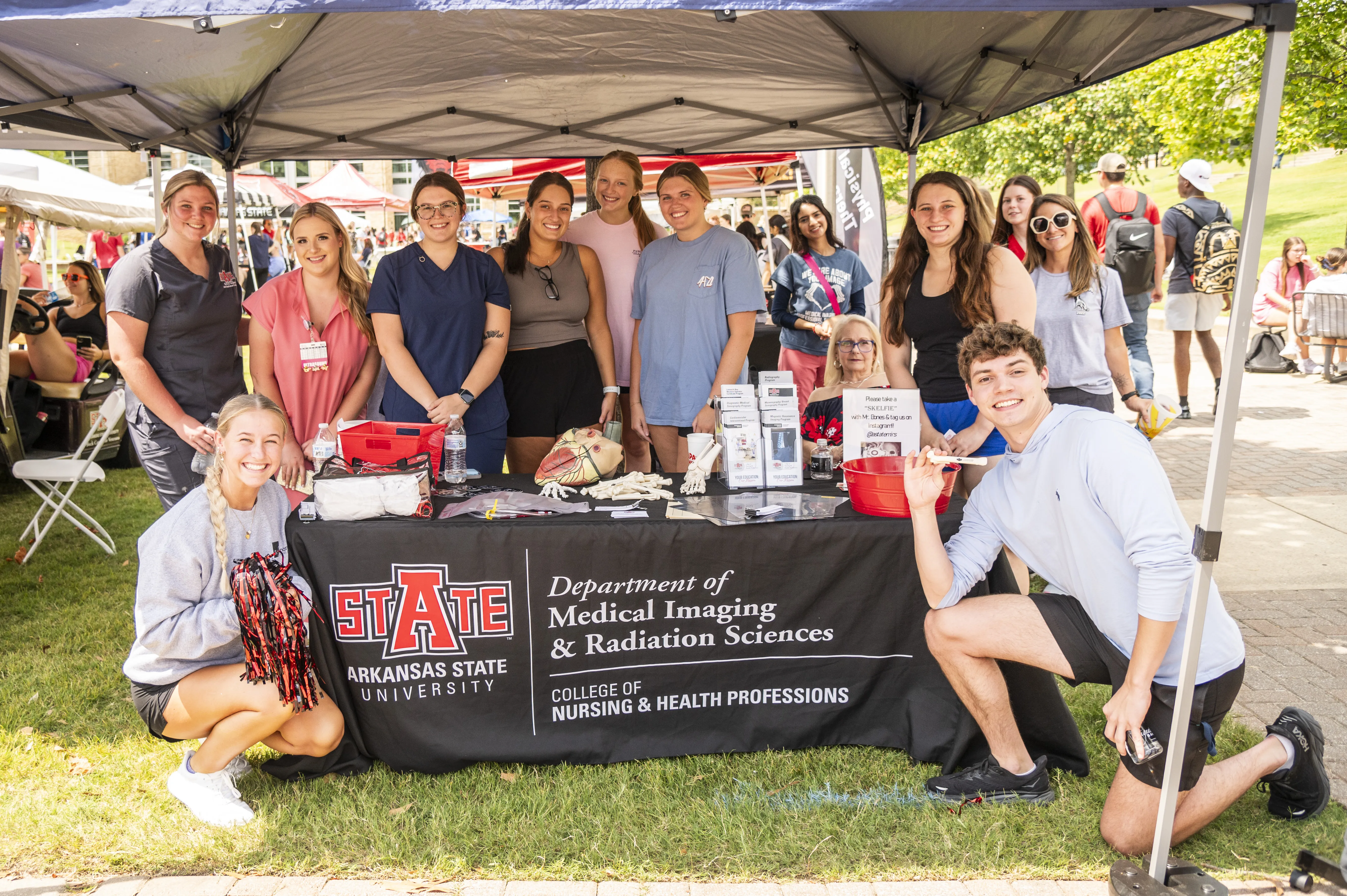 Radiology Students at a tent outside at a college fair event.