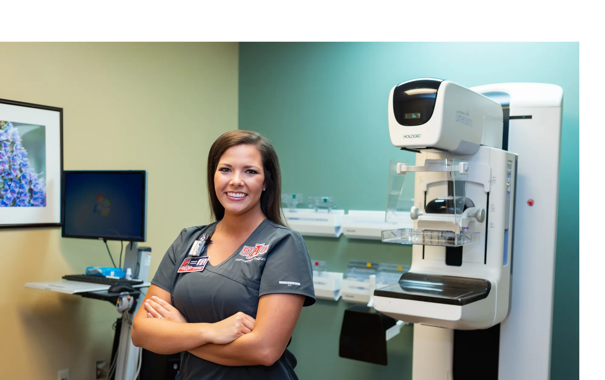 Sonography Student posing by sonography machine