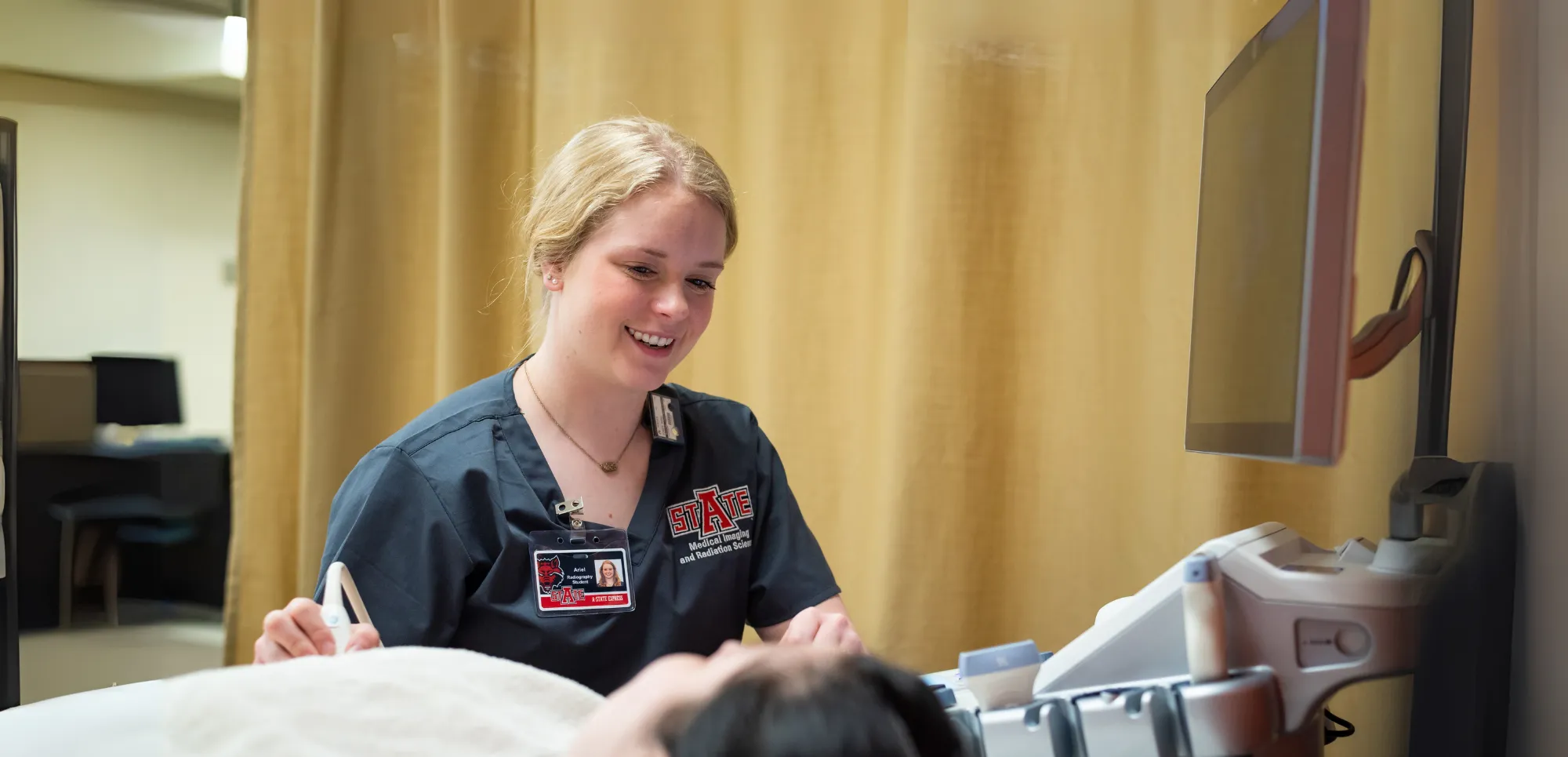 A-State radiology student performing sonography on another student.