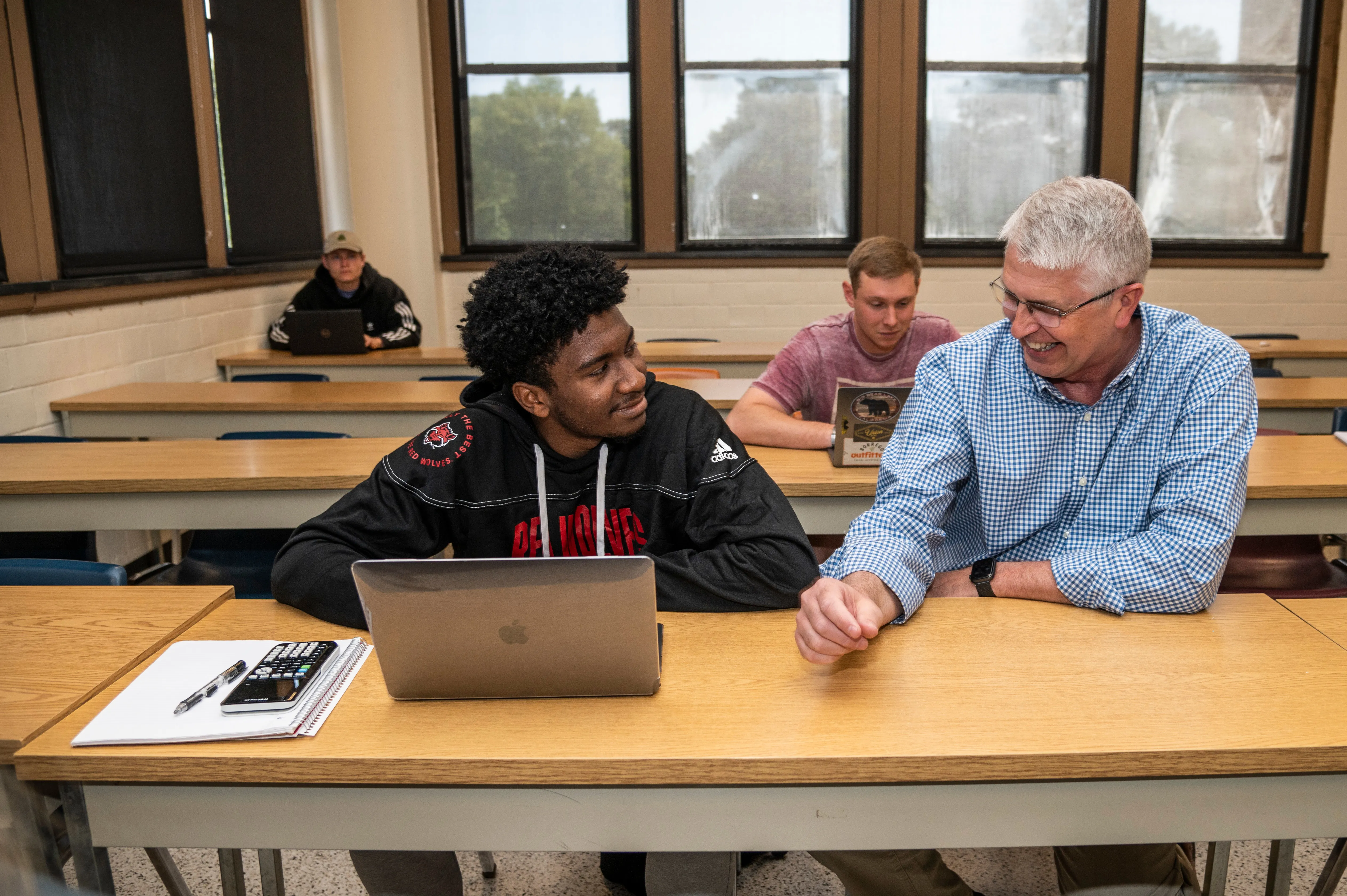 A-State student and teacher having one on one help in class.