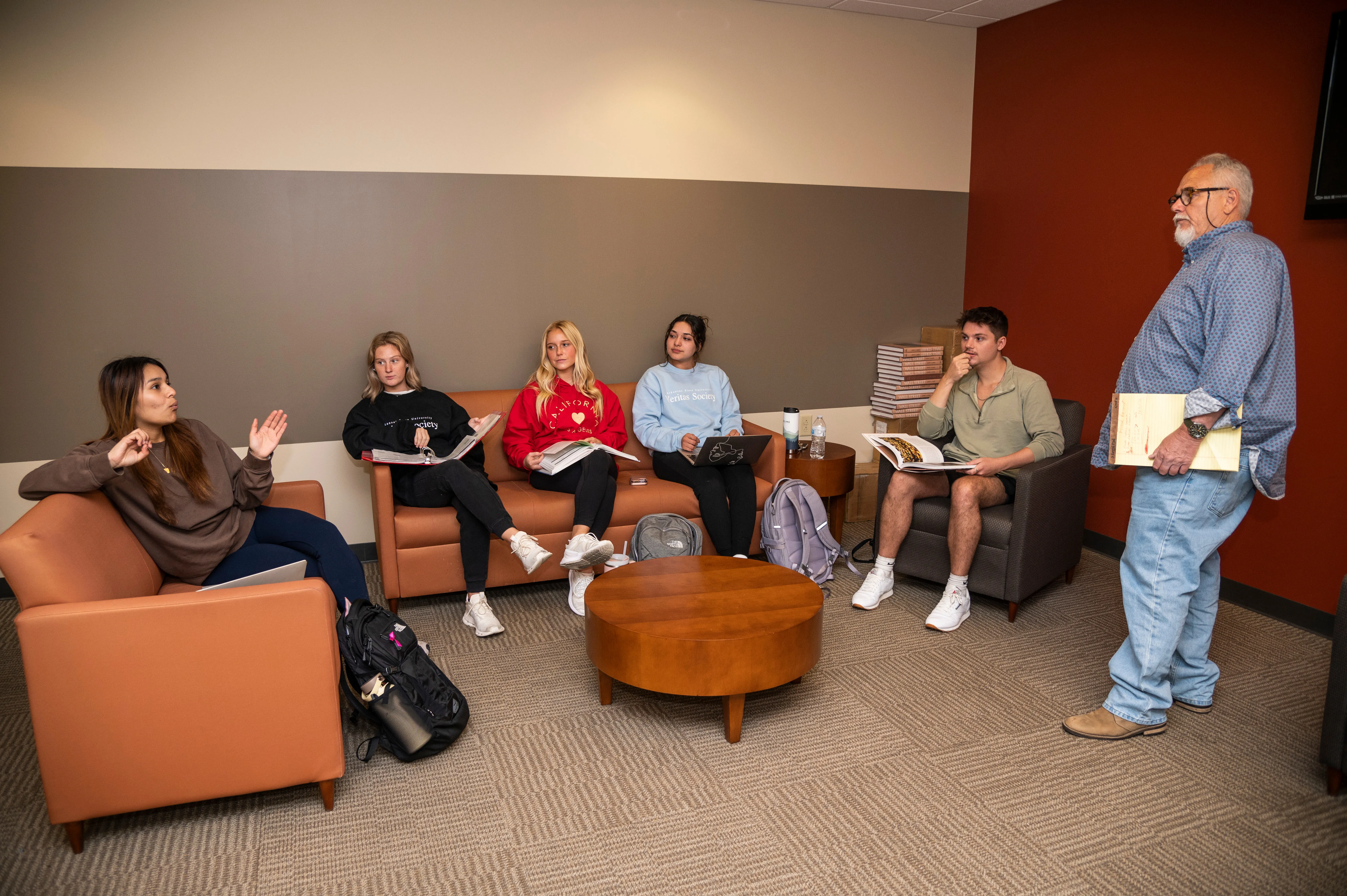 Teacher and students having class in the banking and finance lounge.