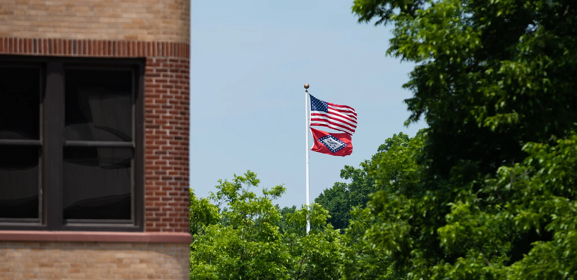 The U.S. and Arkansas flags flying on campus.