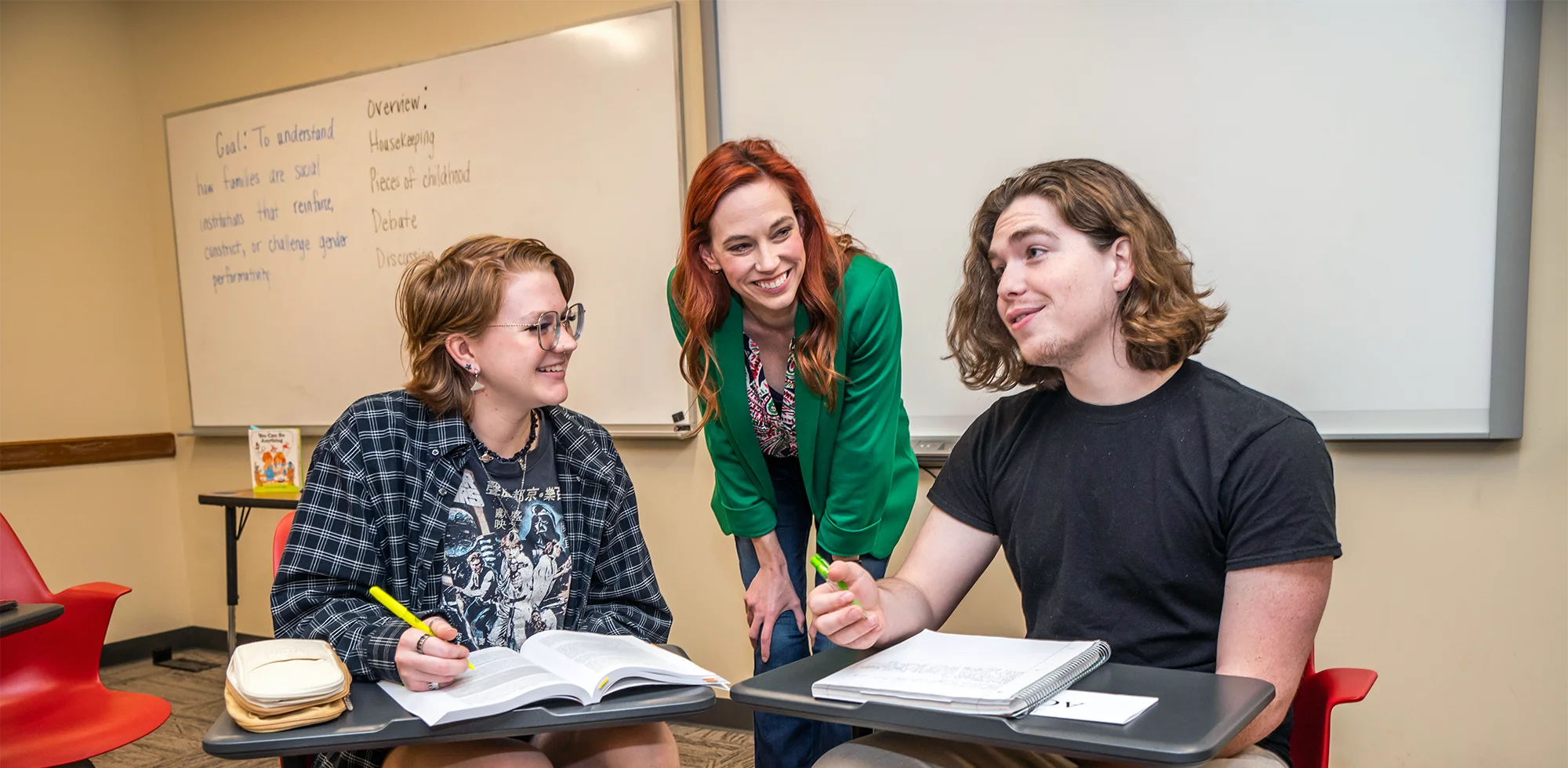 A Women and Gender Studies professor laughing with students.