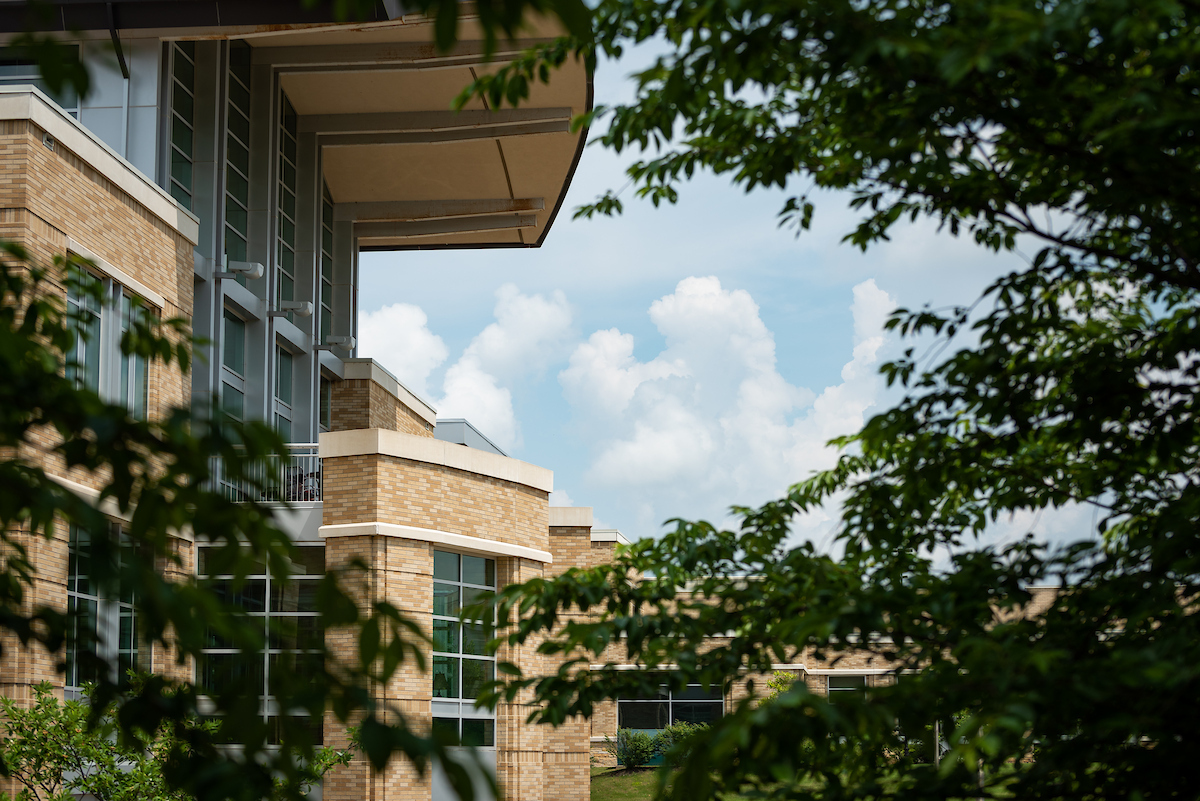 Carl R. Reng Student Union surrounded by magnolia trees in the summer.