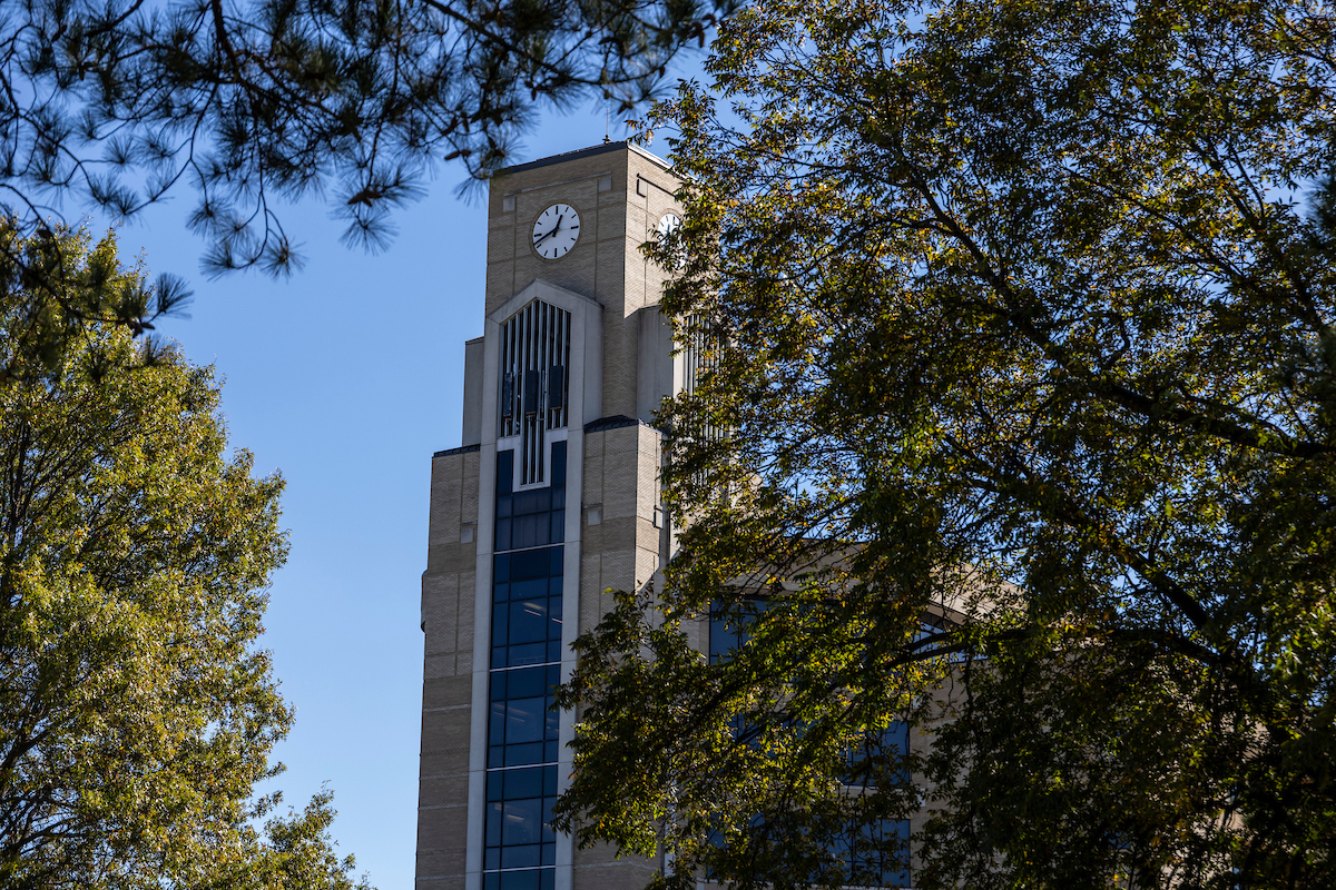 The Dean B. Ellis Library clock tower amongst trees