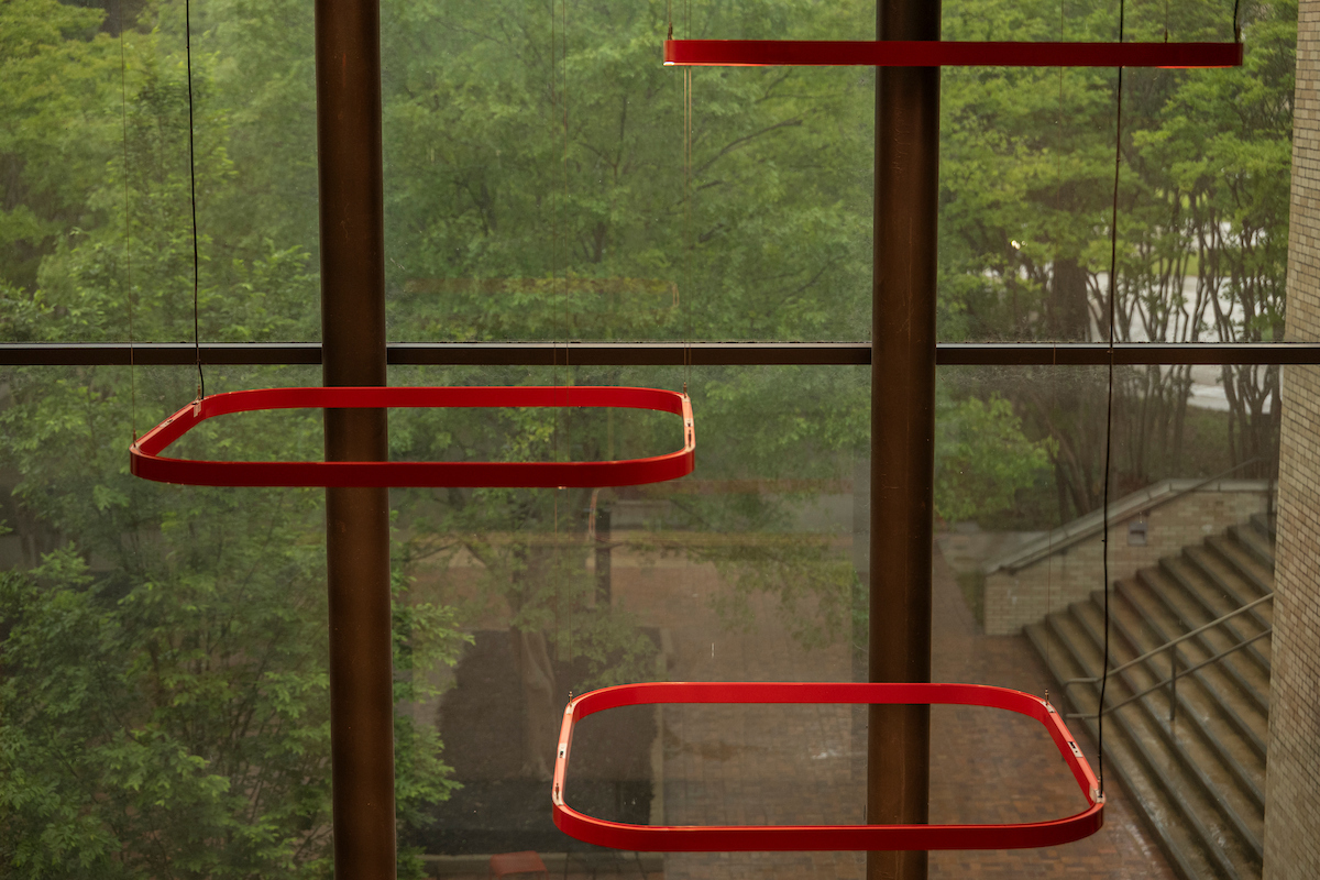 An eccentric light fixture illuminates the Education and Communication Building.