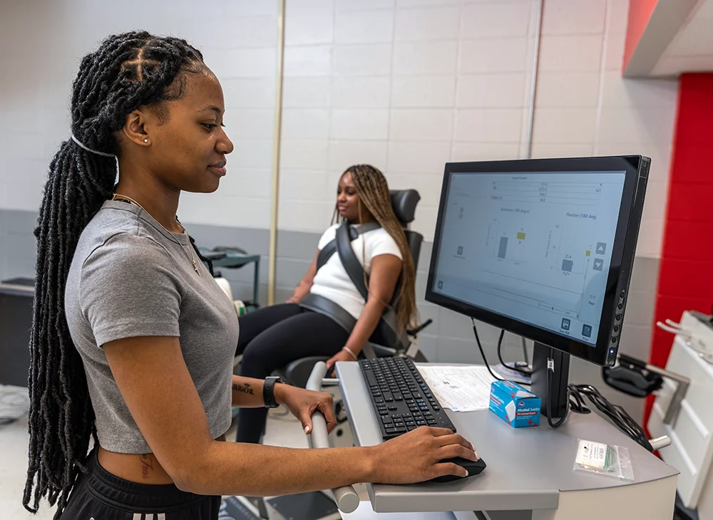 Two students performing an exercise science experiment.