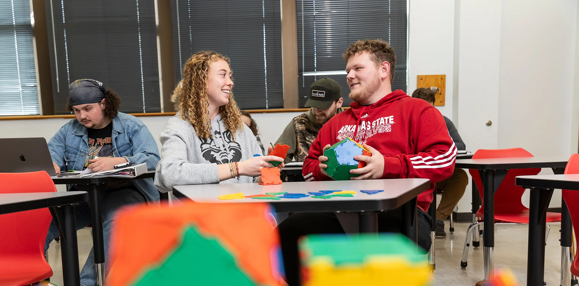 Students building 3D shapes in a mathematics class.