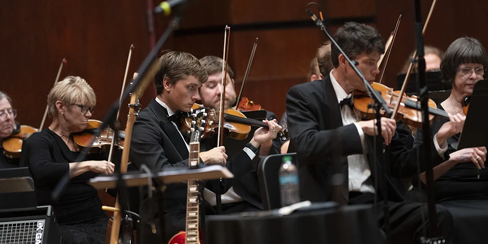 The orchestra playing a song.