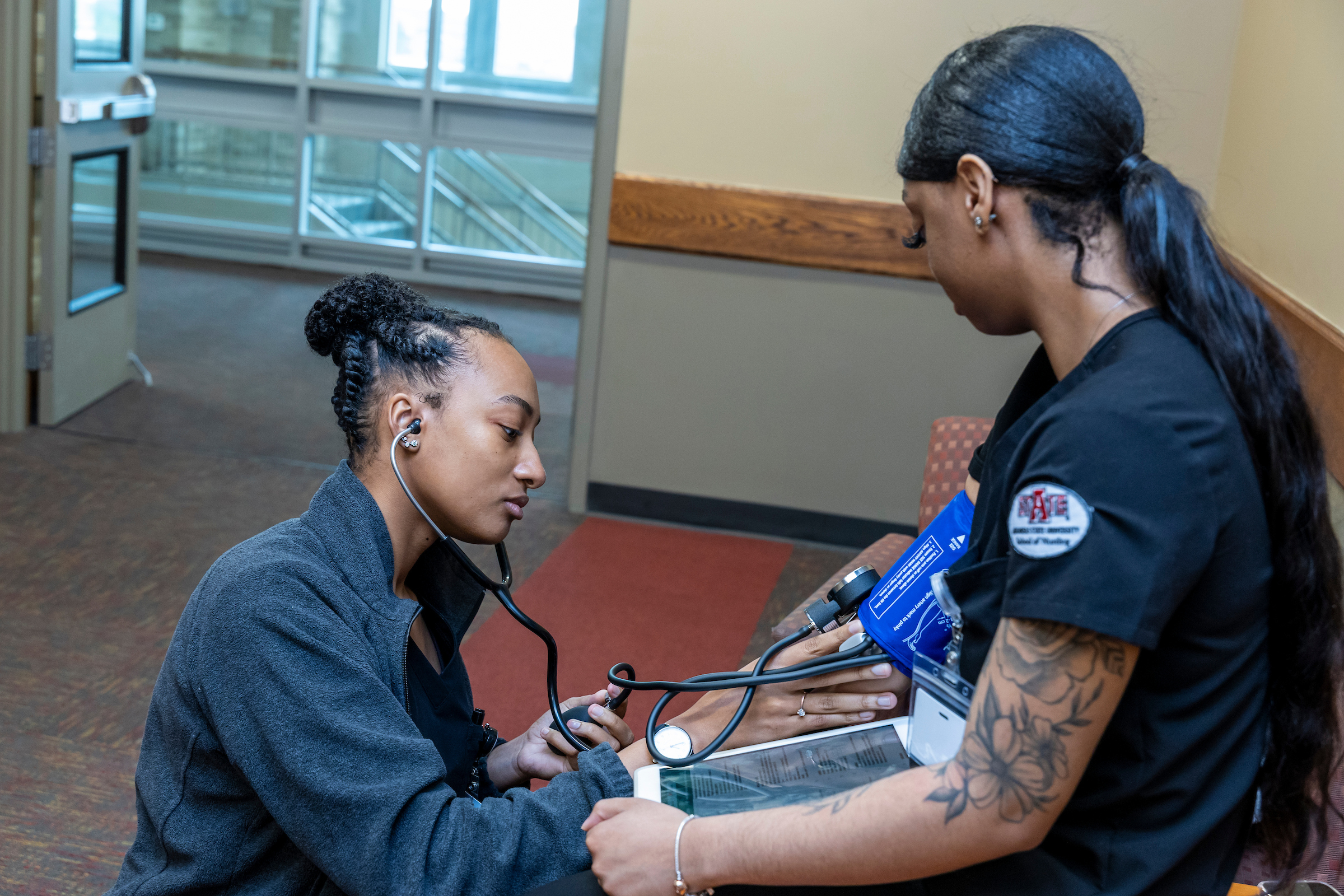 A student getting their blood pressure checked on campus.