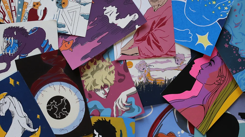 A pile of colorful printmaking work done by students.