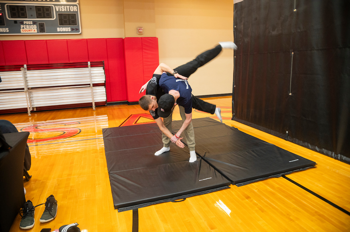 Students grapple in a self defense class on campus.