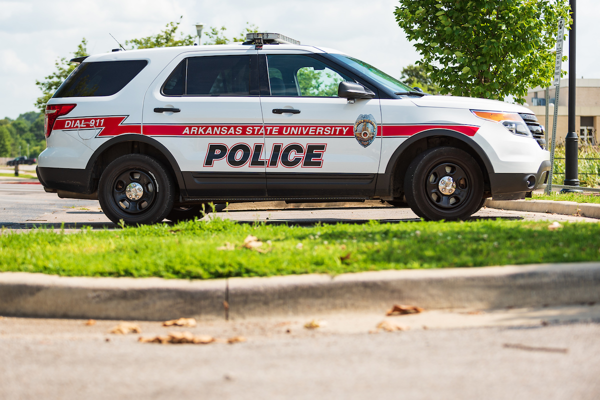 A police cruiser is parked on campus.