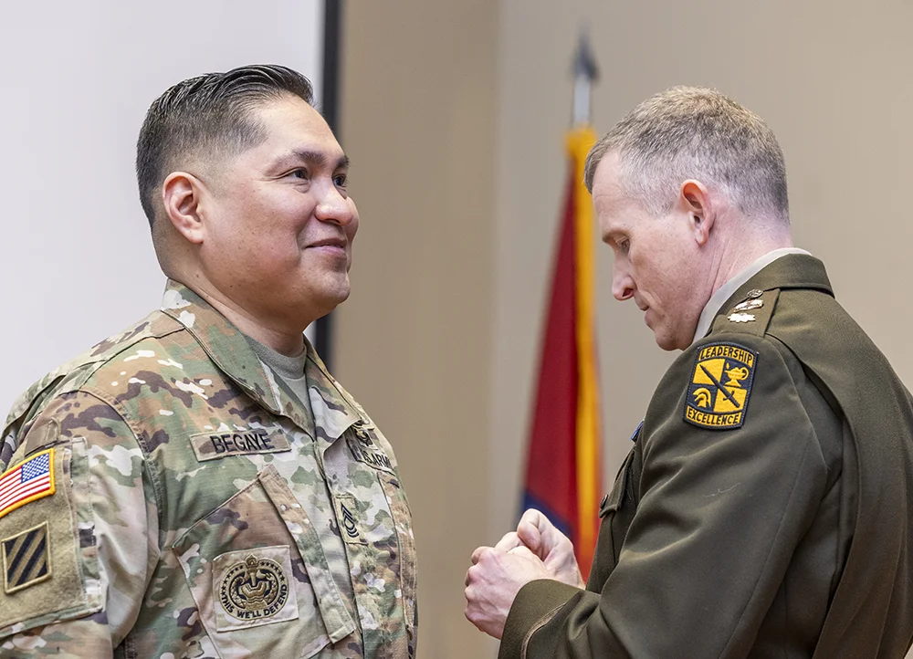 Graduating ROTC student receiving a pin.