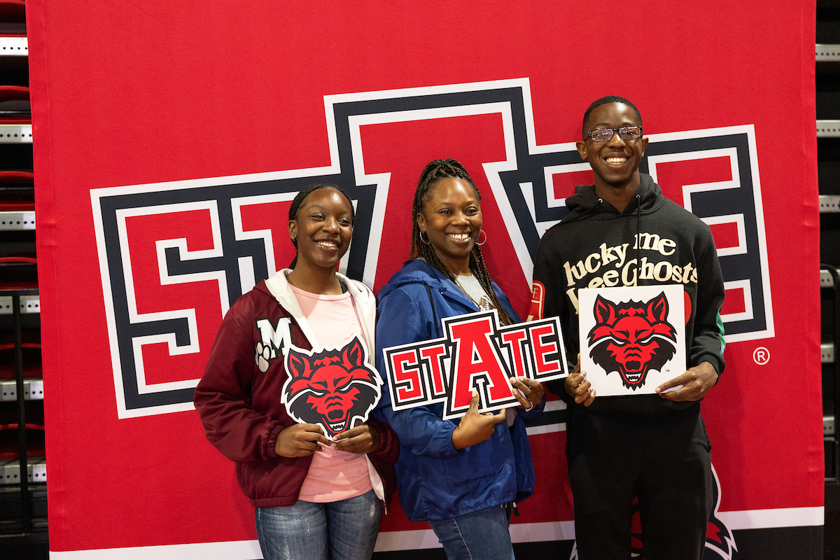 Newly admitted students pose in front of an A-State Backdrop.