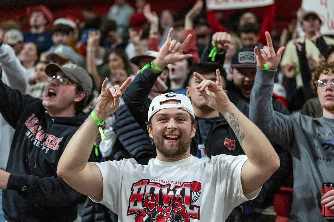 Red Wolves fans cheering at a game.