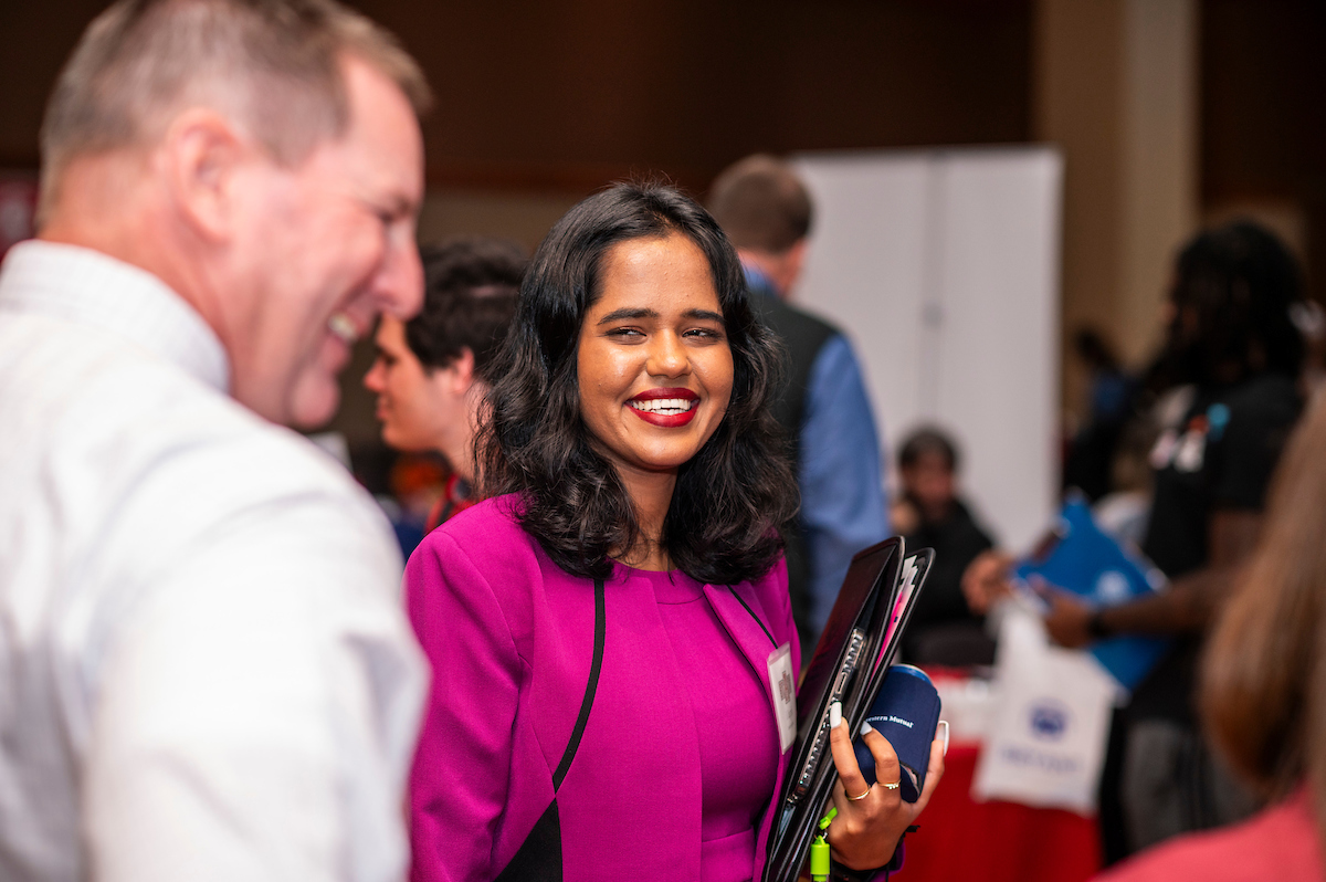 A-State student smiling at a business networking event.