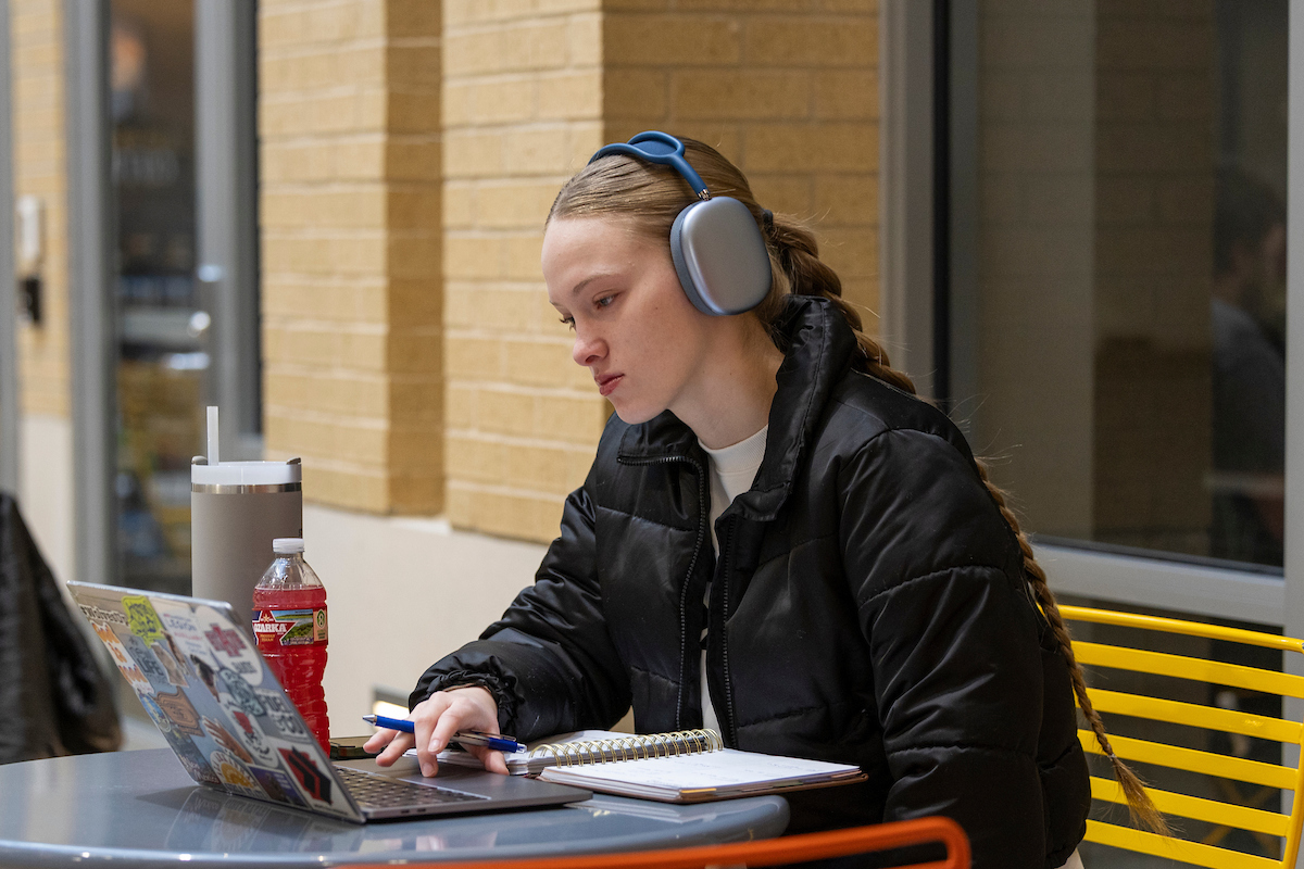 A student using a laptop.