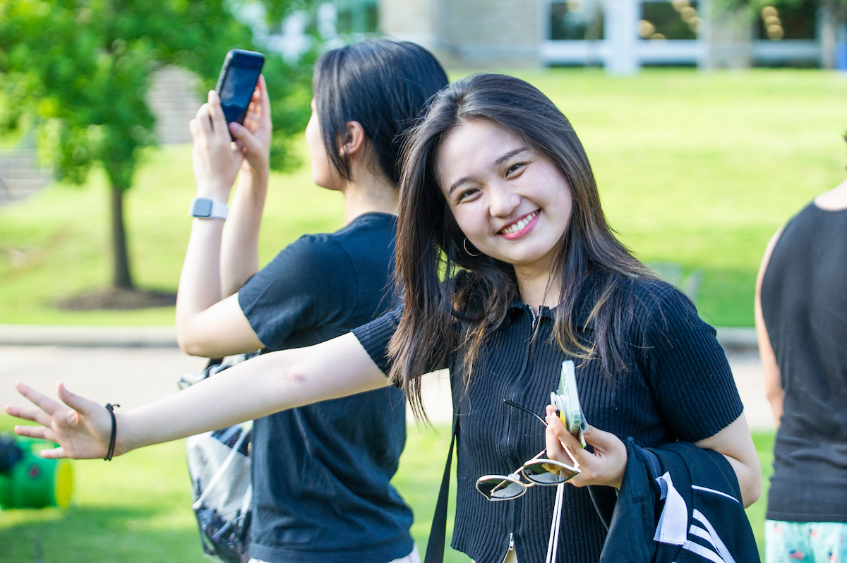 An international student smiles during a student engagement event on campus.
