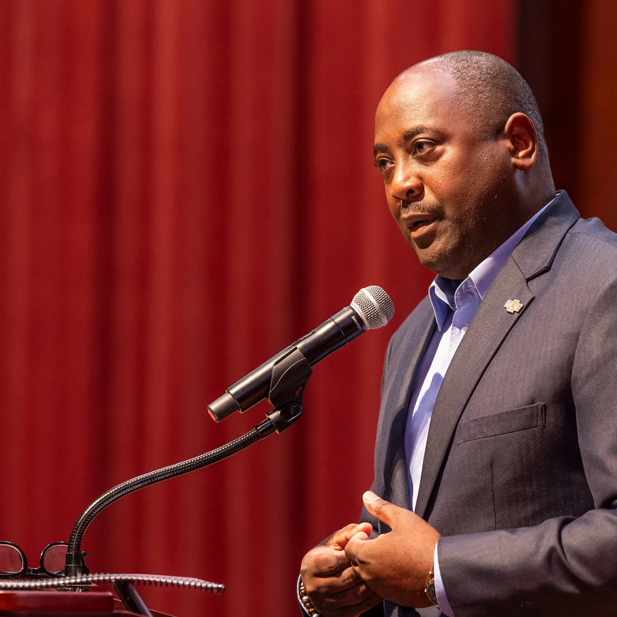 Dr. Calvin White addresses the faculty from a podium