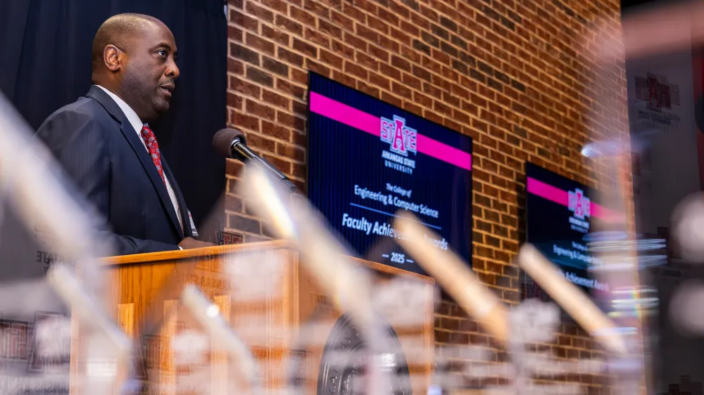 Dr. White giving a speech during the awards ceremony for the Alumni Academy.