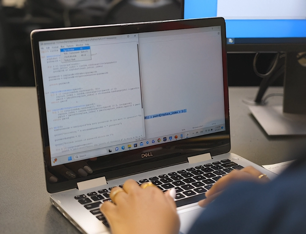 Computer science student coding in class.