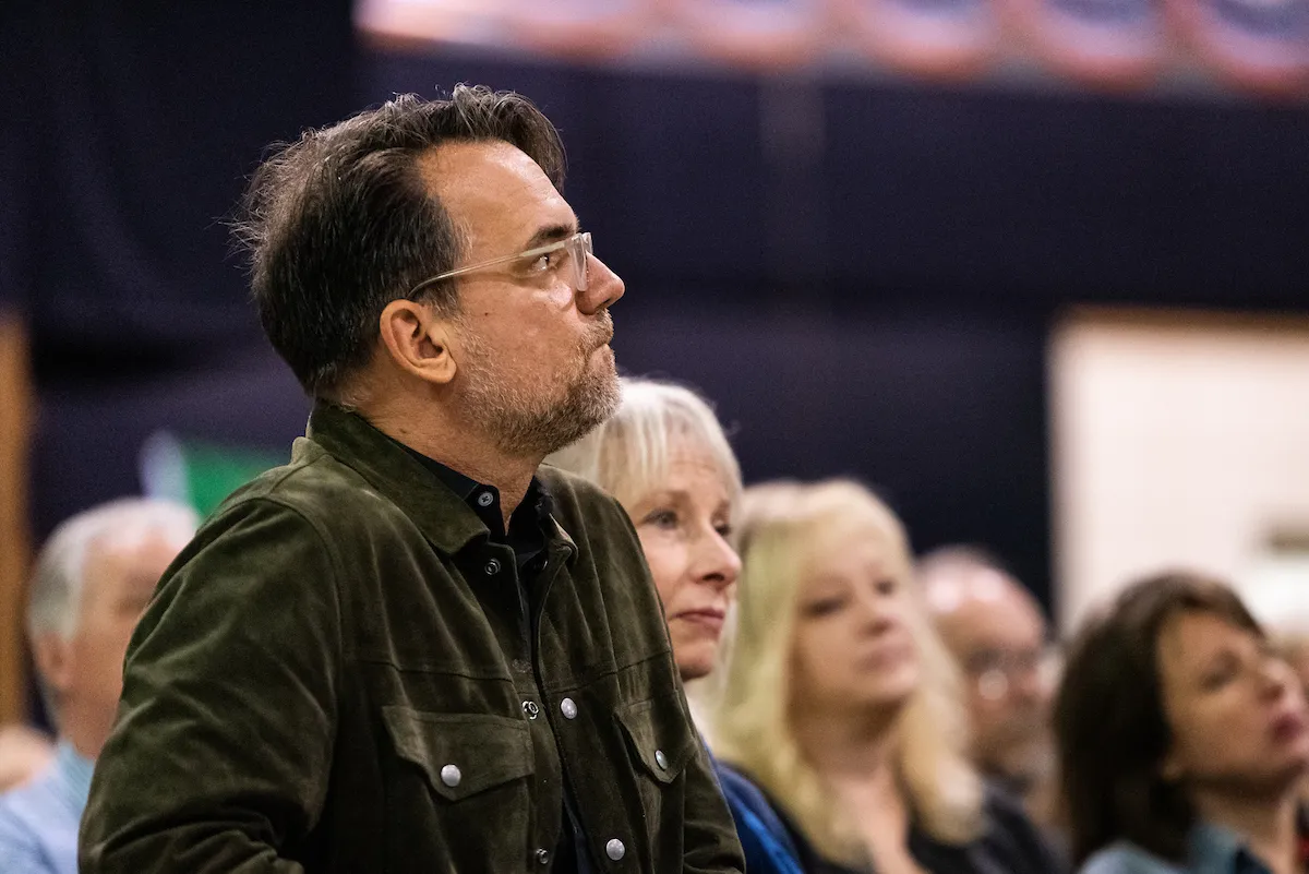 An attendee watches a presentation at Delta Symposium