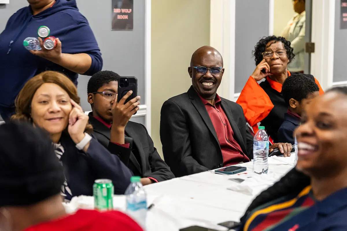 Employees enjoy food and conversation during a lively soul food dinner held on campus.