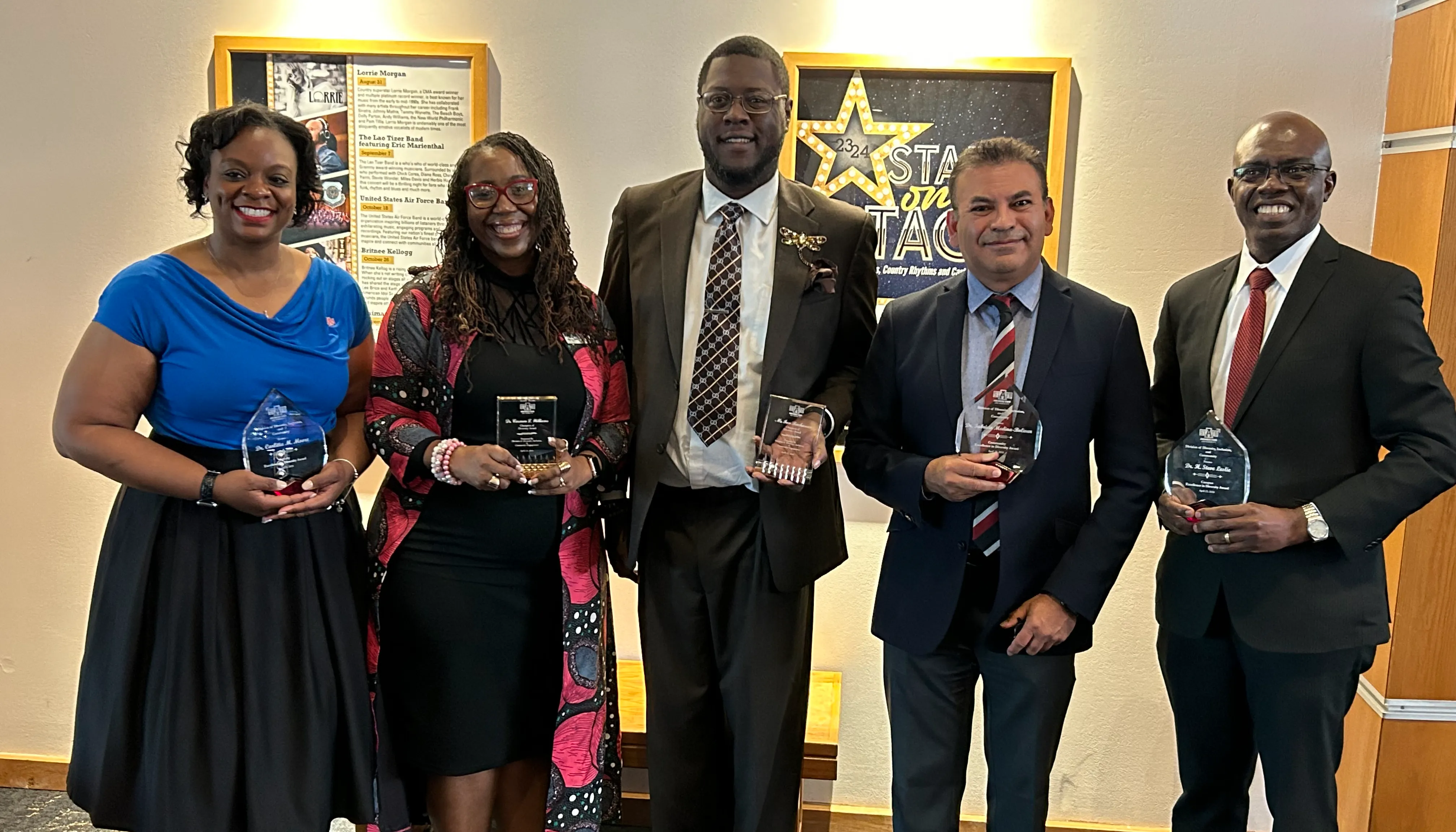 A previous group of campus winners pose with their trophies