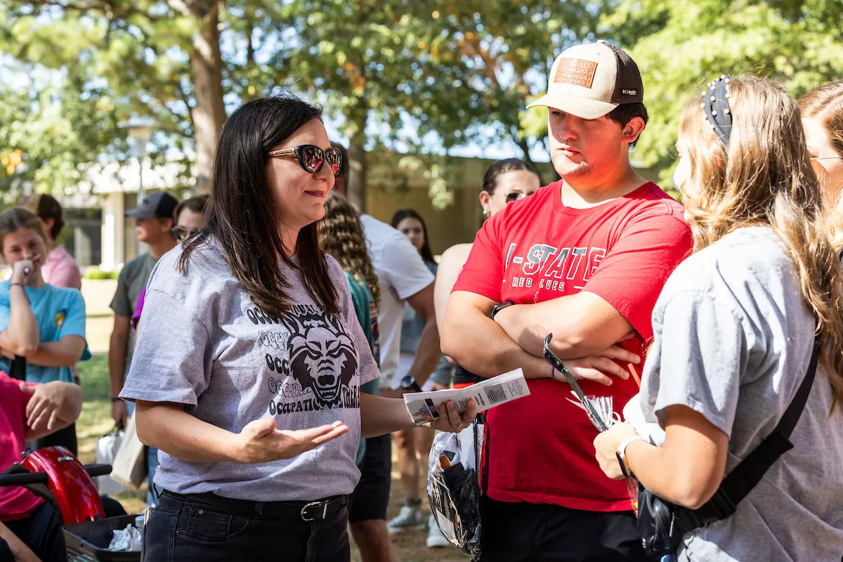 A prospective student and his mother meet with a faculty member in Occupational Therapy
