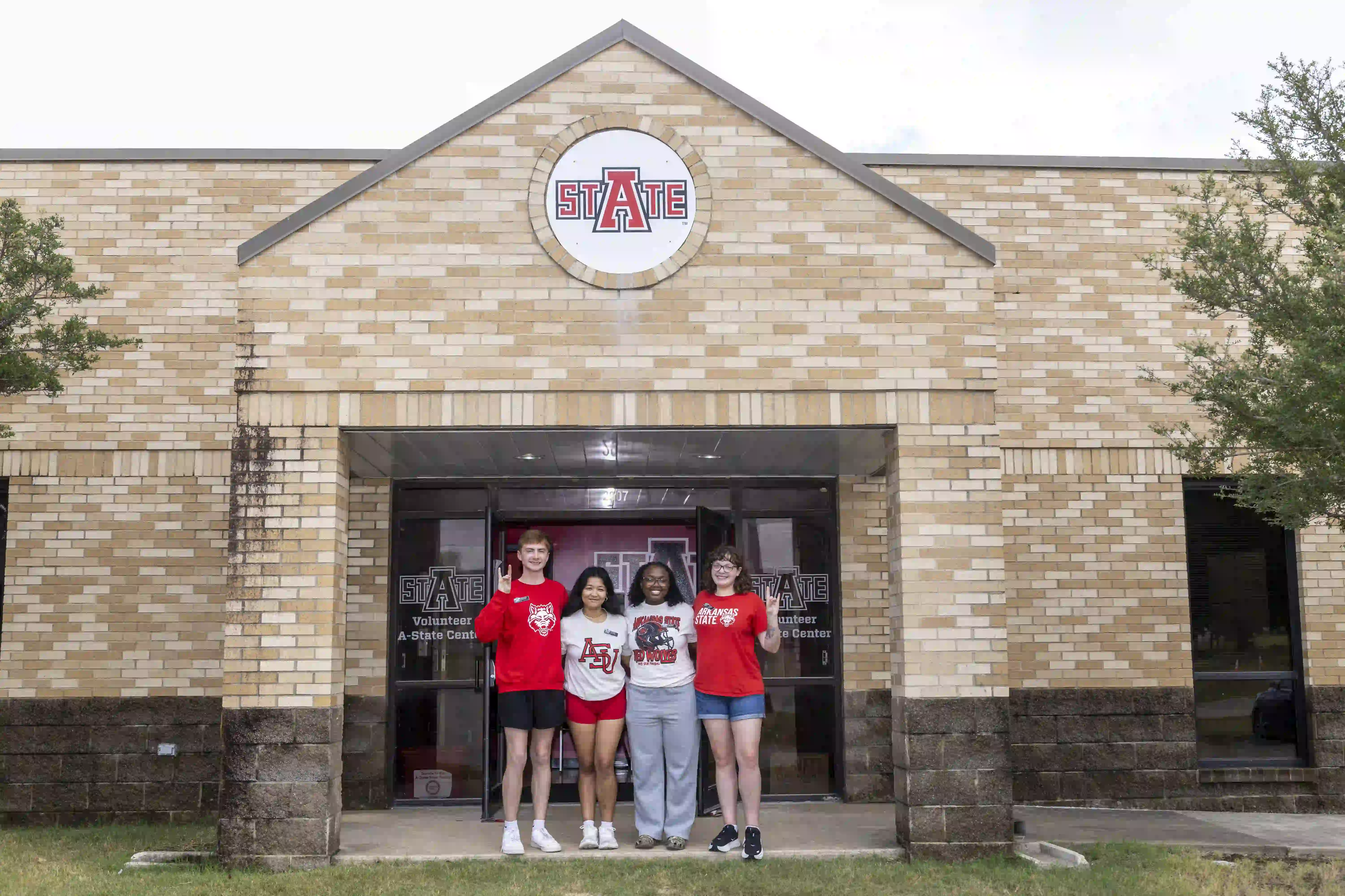 Students posing in front of A-State Food Pantry building.