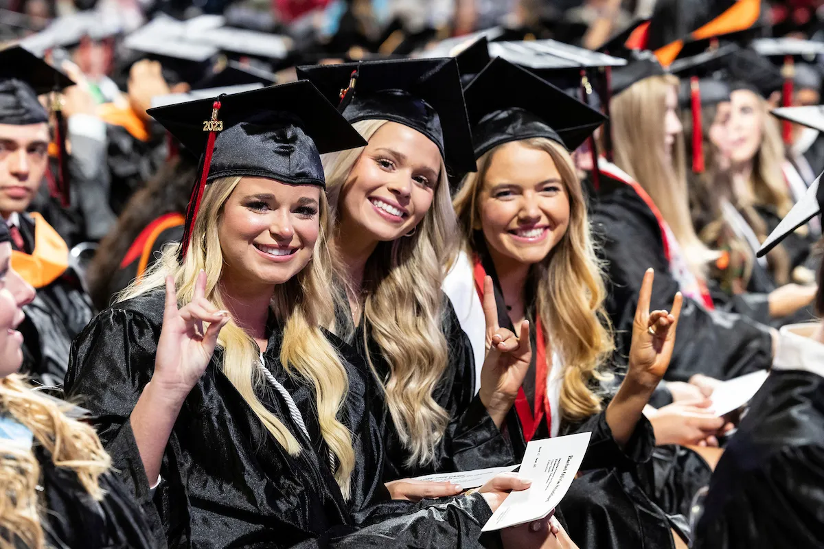 A group of students put their Wolves Up during a recent commencement ceremony.