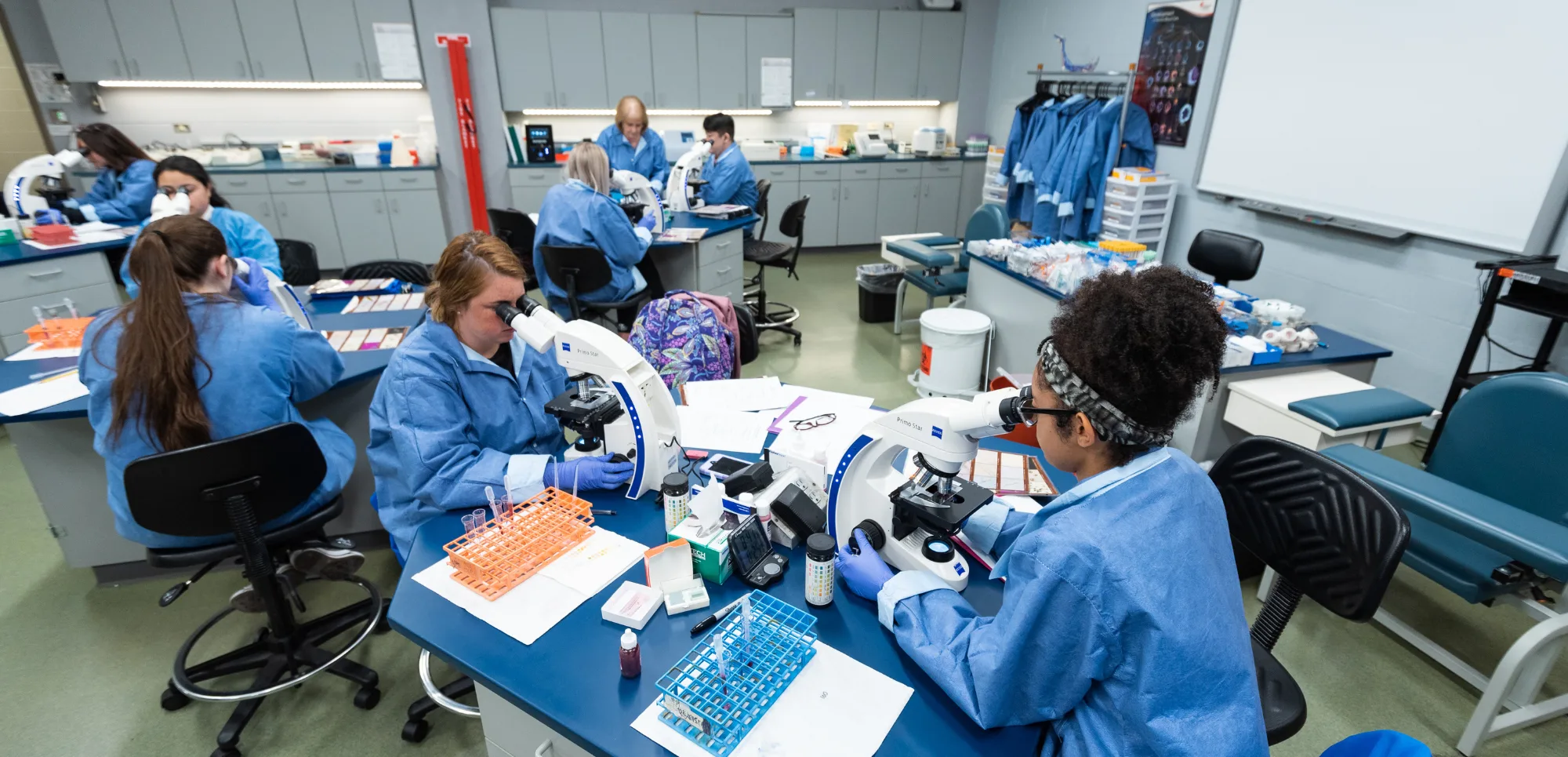 Clinical lab science students working together in class.