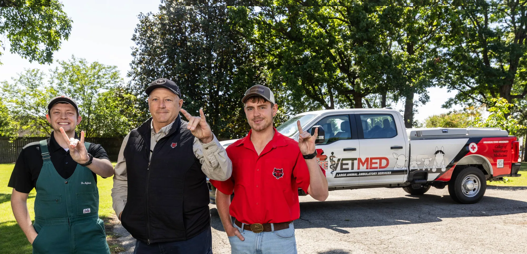 A-State College of Veterinary Faculty, Dr. Neyland and Dr. Reiners standing by the services' A-State Branded Truck.