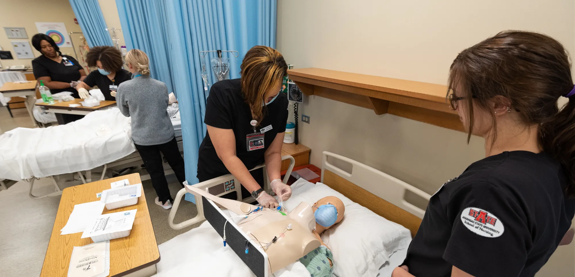 A-State nursing students are working on labs with dummies.