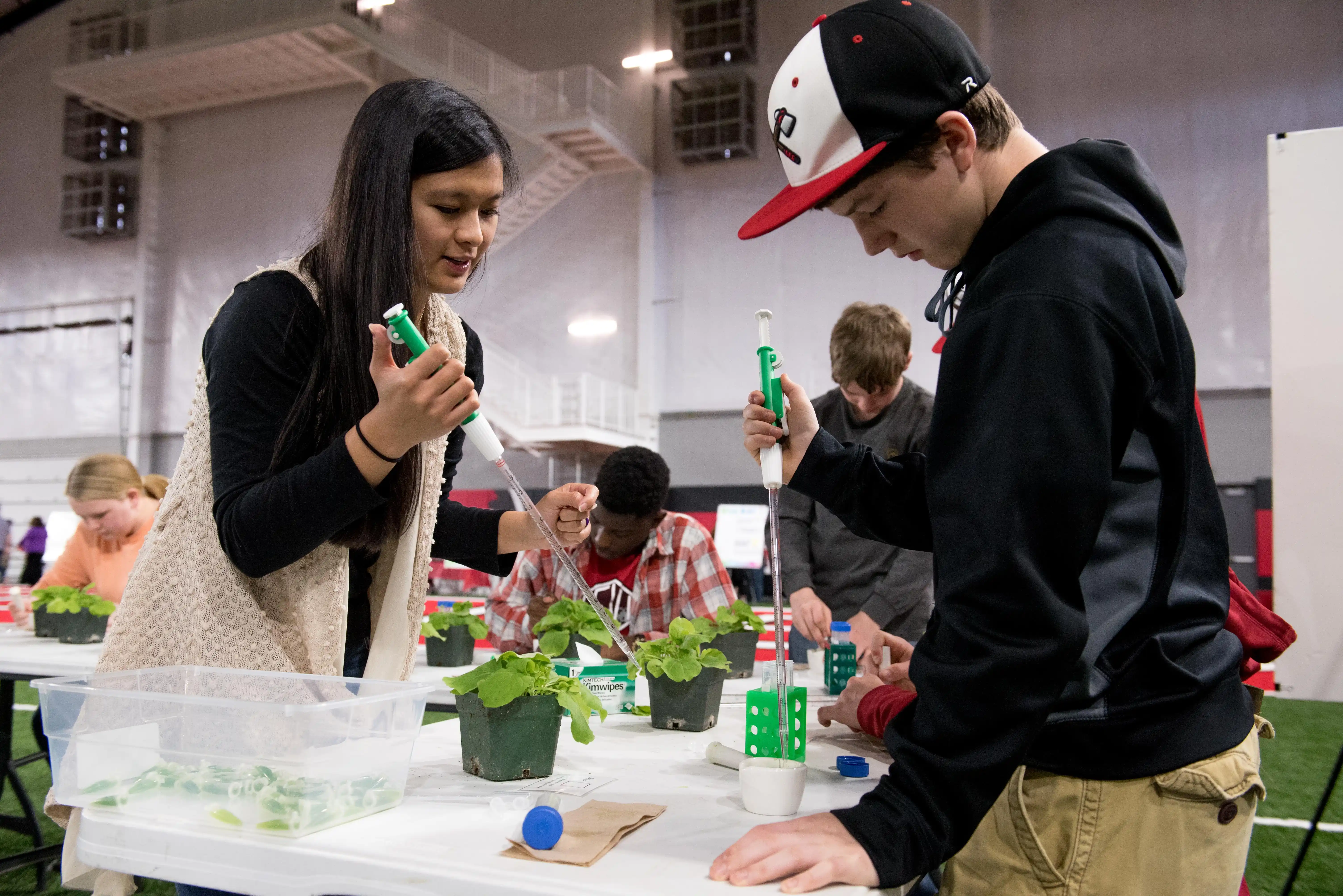 An A-State student provides help to a K-12 visitor.