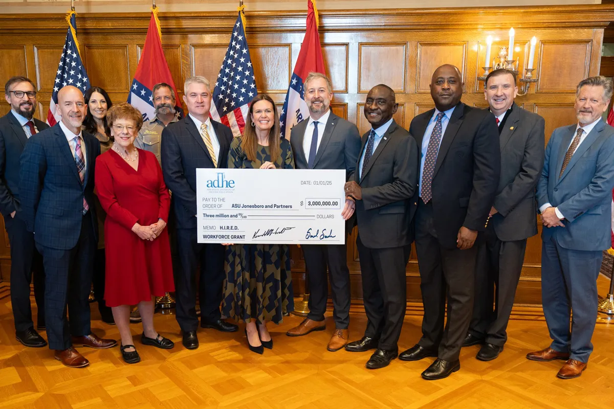 Gov. Sarah Sanders awards the HIRED grant to a group of recipients from NEA.