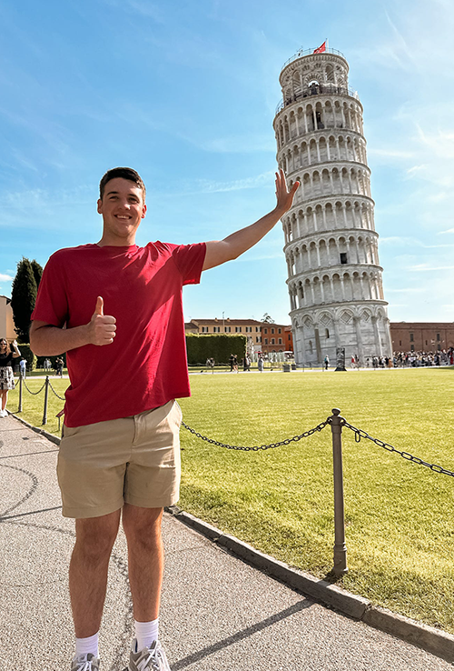 Student posing with Leaning Tower of Pisa during Global Student Leader study abroad trip.
