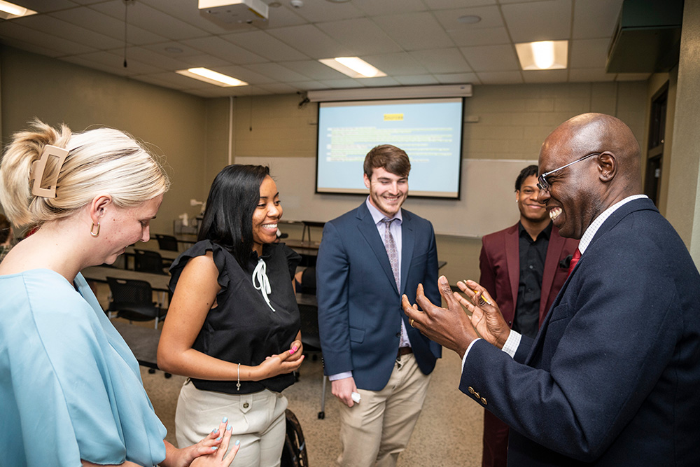 Instructor Speaking with Students