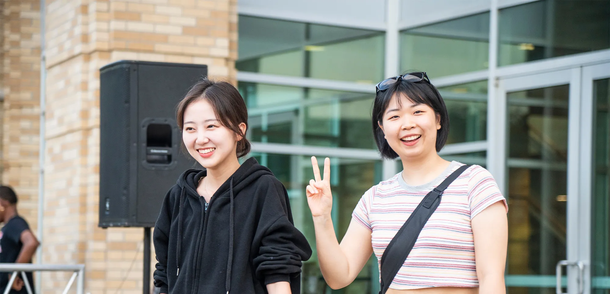 Smiling students exiting the student union building