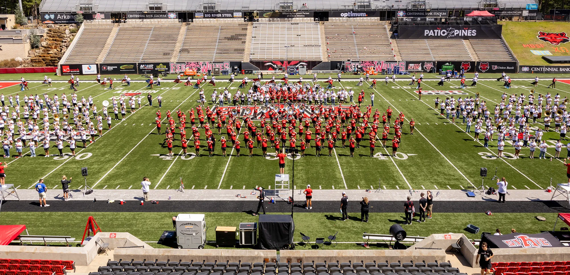 A-State band, along with area high school bands, on the field at Centennial Bank Stadium