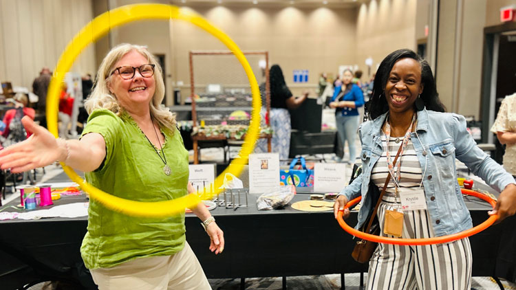 Two women use hoola hoops