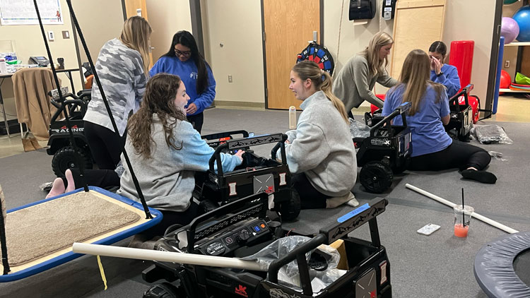Students work on toy ride-on cars