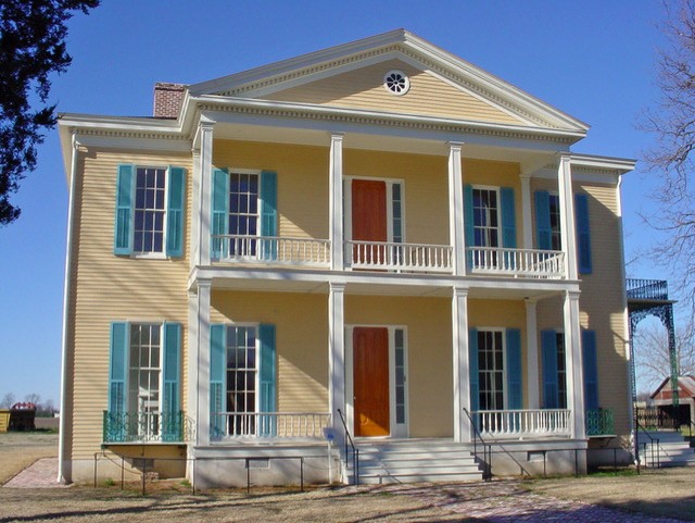 yellow house with blue shutters