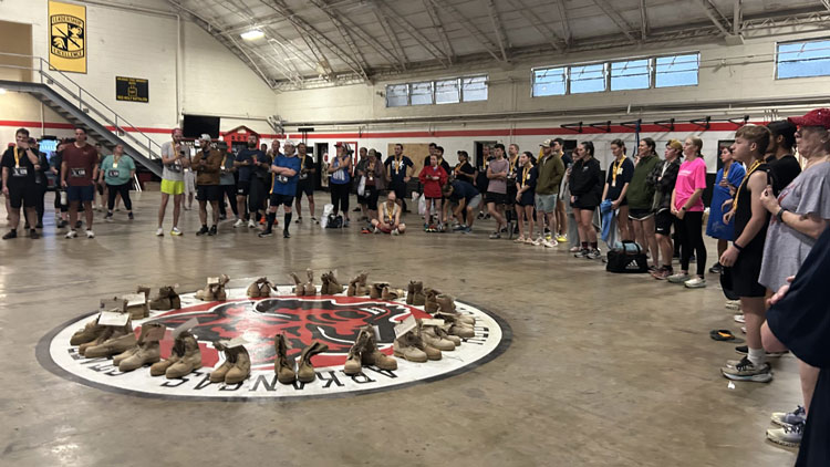 Boots in a circle and participants standing in a circle. 