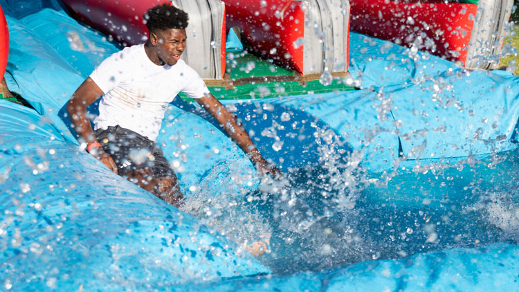 Student slides down slide.