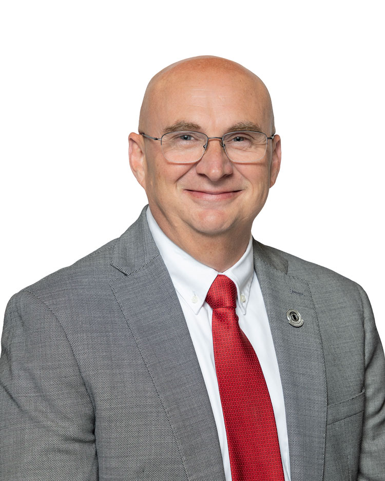Photo of man in grey jacket and red tie