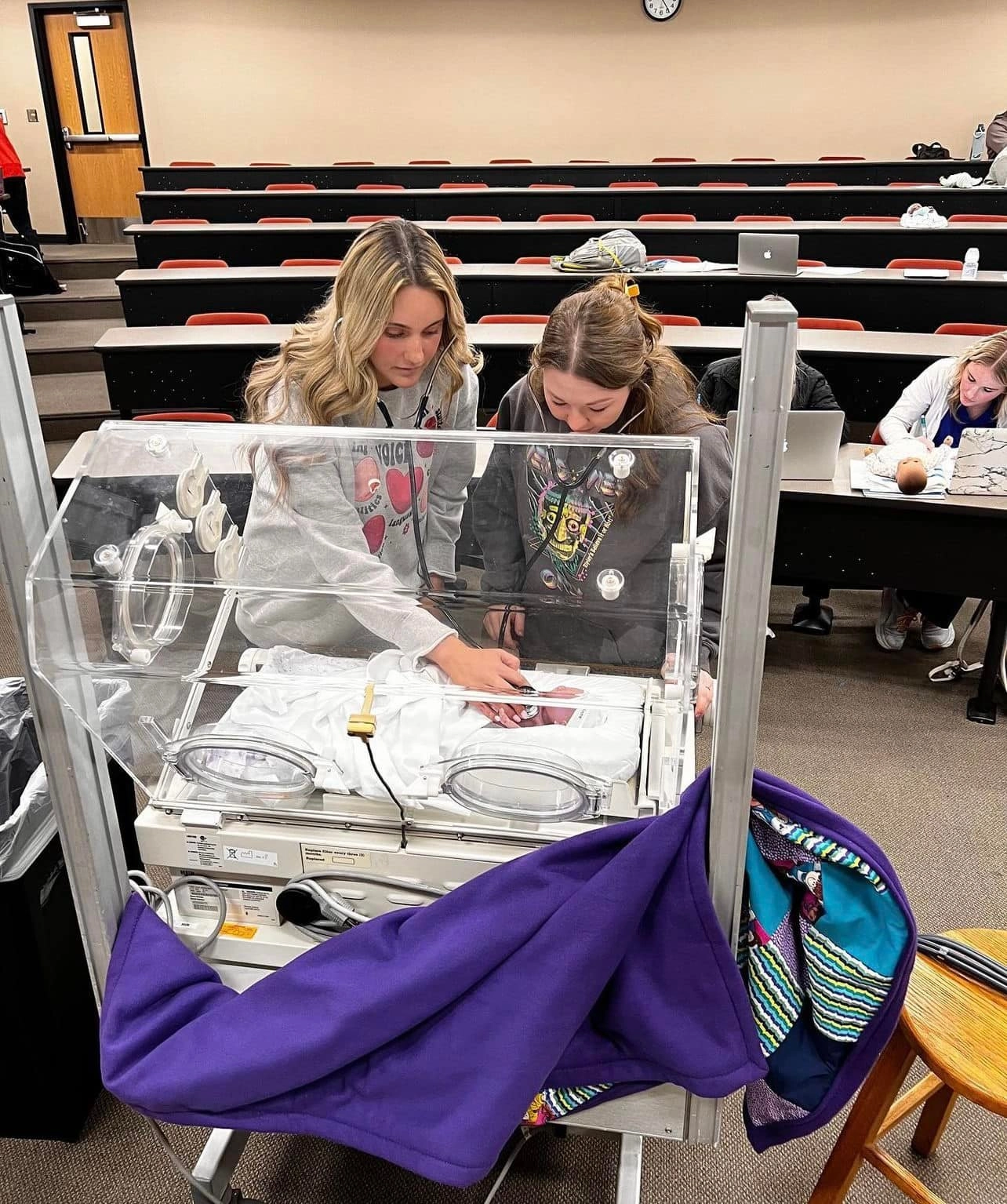 A-State communication disorders students working on a nic u lab.
